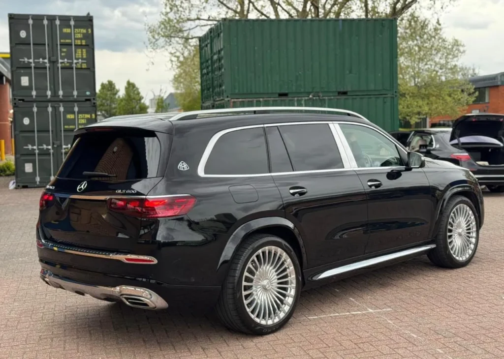Rear three-quarter view of a black Mercedes-Maybach GLS 600 with Maybach badge and chrome exhaust trims
