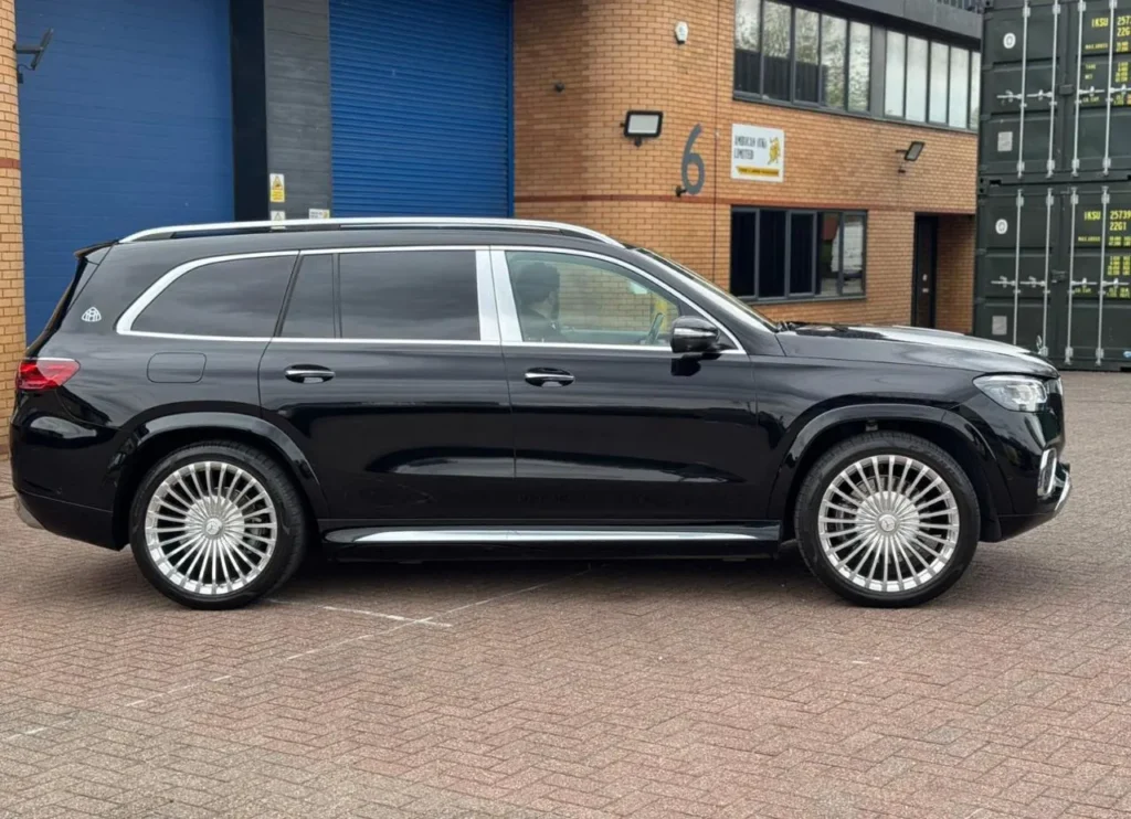Side profile of a black Mercedes-Maybach GLS chauffeur SUV with chrome running boards