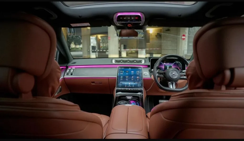 Mercedes S-Class interior dashboard with central touchscreen, digital cockpit and ambient lighting
