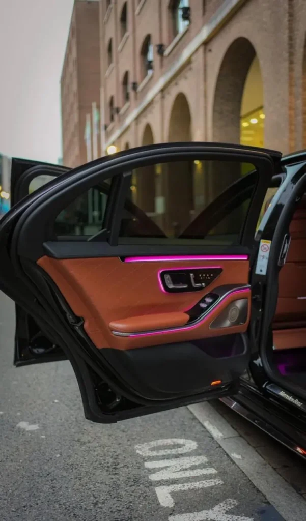 Mercedes S-Class rear door open with tan leather trim and ambient lighting on a London street