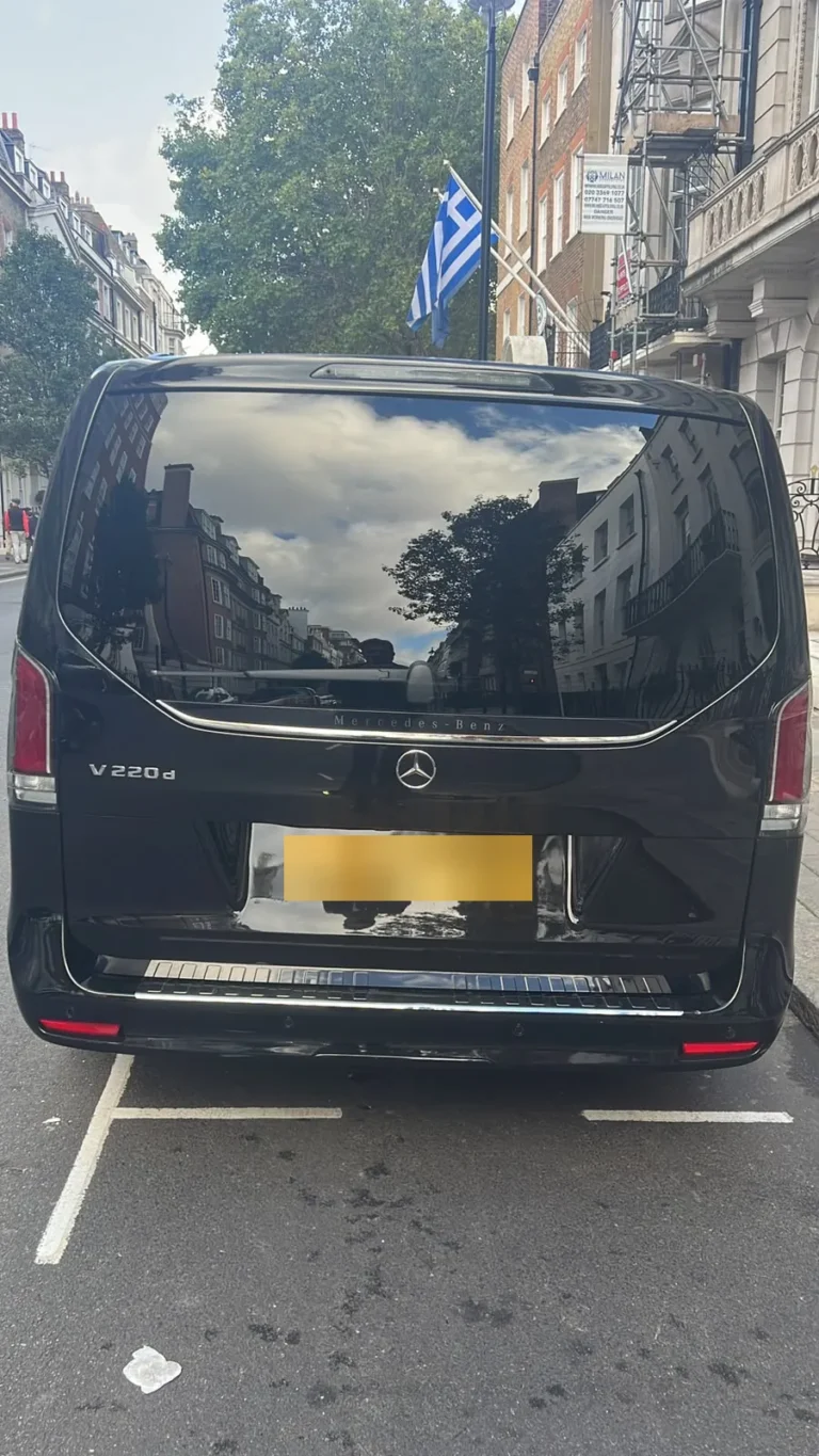 Rear view of a black Mercedes V-Class V220d chauffeur MPV parked on a London street