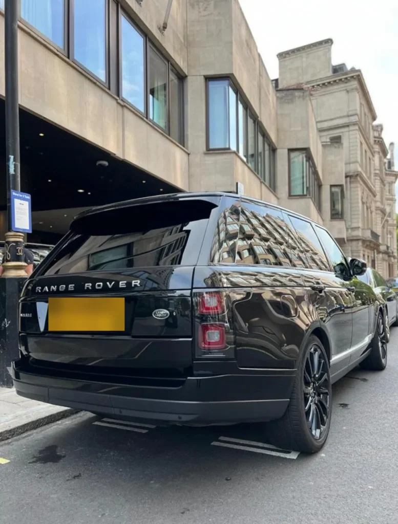 Black Range Rover Vogue luxury SUV with gloss black alloy wheels on a London street