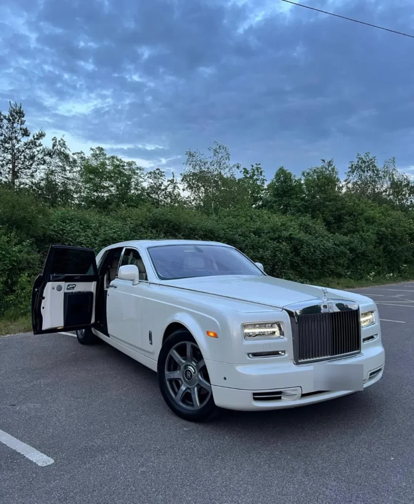 White Rolls-Royce Phantom wedding car with rear coach door open showing white leather interior